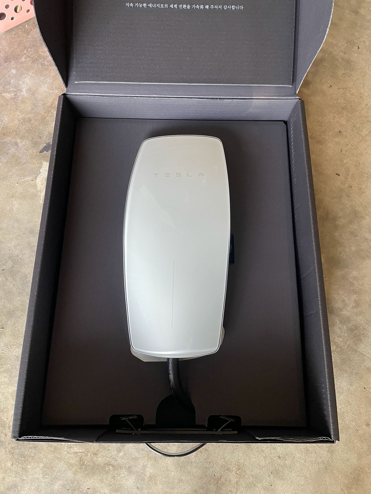 A Tesla Wall Connector before installation.